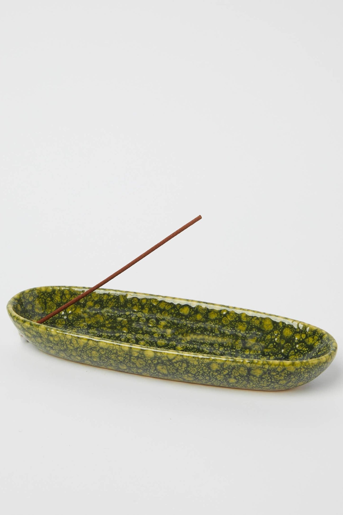 Green stone incense holder on a white background