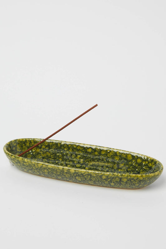 Green stone incense holder on a white background