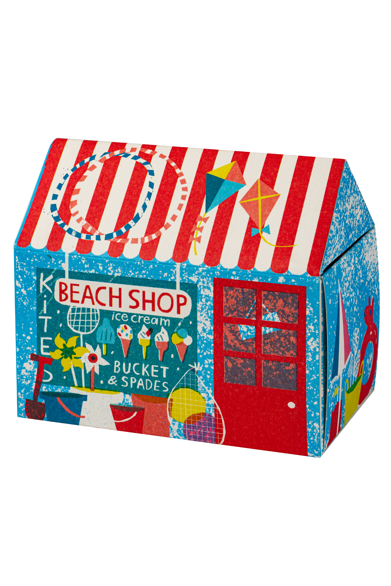 A colorful house-shaped decorative box printed with a beach shop theme, featuring red and white striped roof, blue sides, a red door, and beach-themed illustrations including kites, ice cream cones, and a sign reading 'BEACH SHOP'.