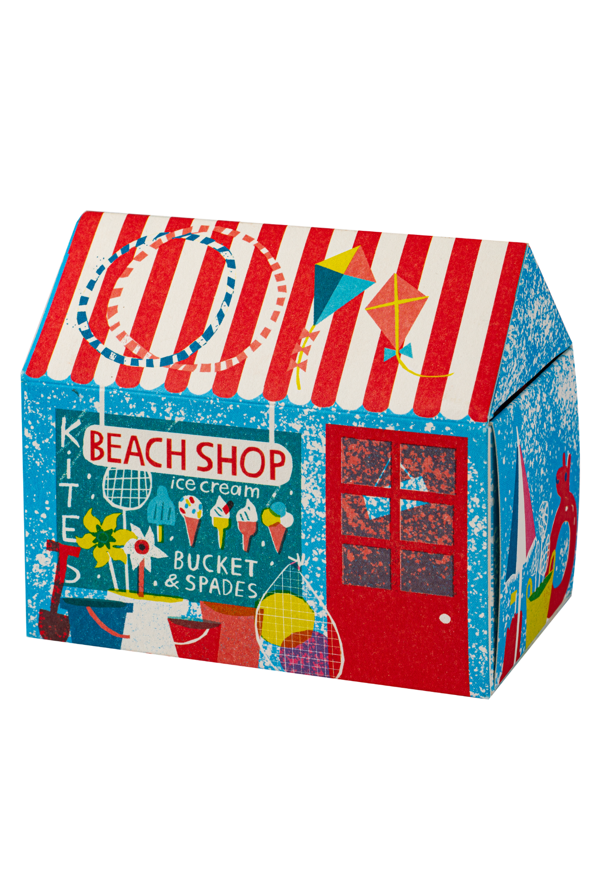 A colorful house-shaped decorative box printed with a beach shop theme, featuring red and white striped roof, blue sides, a red door, and beach-themed illustrations including kites, ice cream cones, and a sign reading 'BEACH SHOP'.