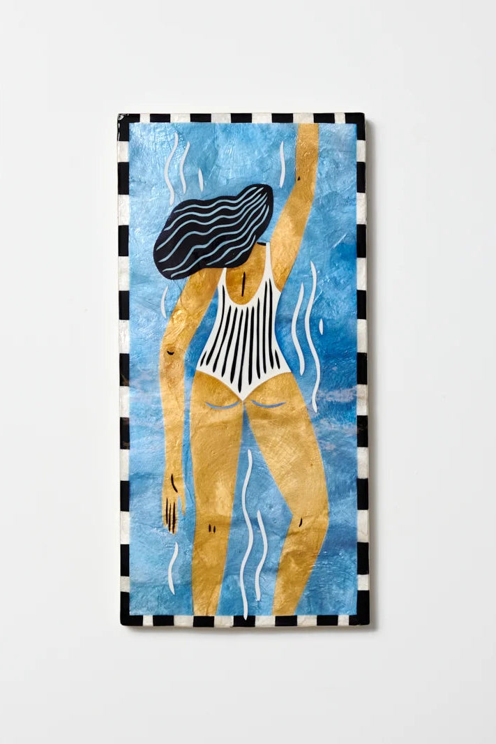 A vertical rectangular art print or poster featuring an abstract illustration of a woman in a black-and-white striped swimsuit against a textured blue background, with a black-and-white checkered border. The print is shown hanging against a light gray wall.