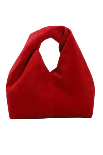 A vibrant red suede slouchy shoulder bag with a unique integrated top handle, photographed against a neutral light gray background.