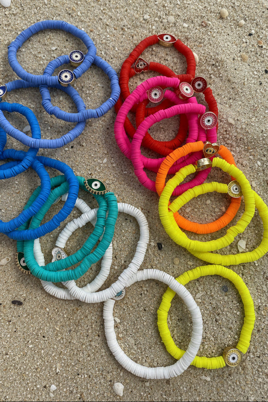 Colorful bracelets on a sandy surface